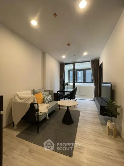 Modern living room with stylish decor and large windows for natural light.