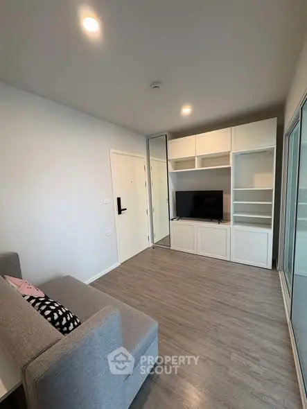 Modern living room with sleek built-in storage and cozy gray sofa