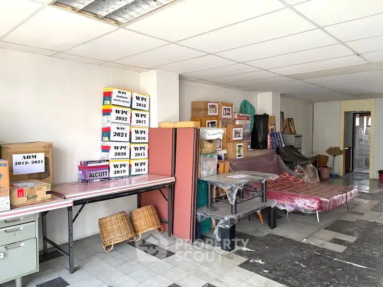 Spacious storage room with organized boxes and ample shelving in a well-lit area.