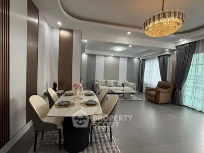 Luxurious living room with elegant dining area and modern chandelier