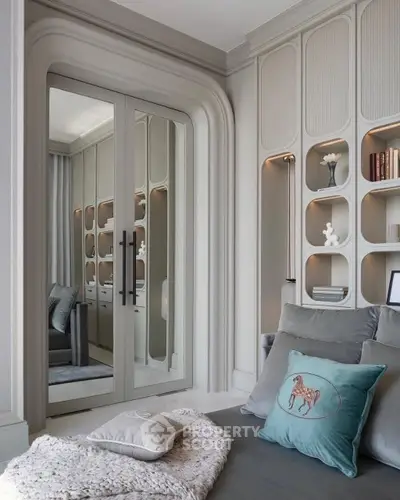 Luxurious modern living room with elegant built-in shelves and plush decor.