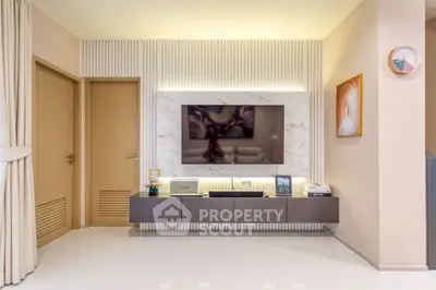 Modern living room with sleek TV unit and elegant decor