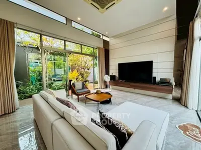 Spacious modern living room with large windows and garden view