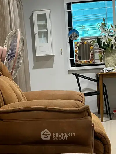 Cozy living room with plush recliner and decorative window view