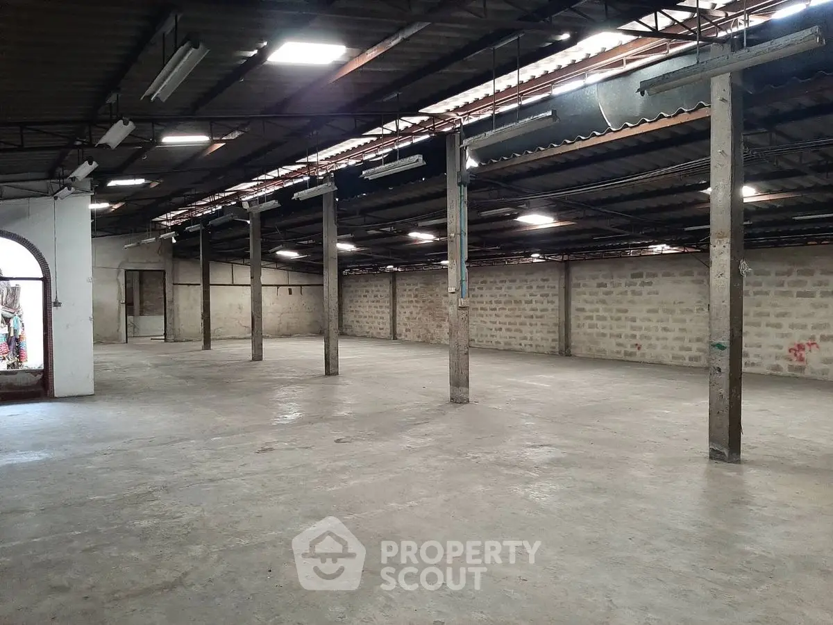 Spacious industrial warehouse with high ceilings and open floor plan, ideal for storage or manufacturing.