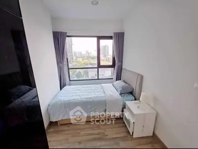 Cozy bedroom with city view, featuring a comfortable bed and modern decor, perfect for urban living.