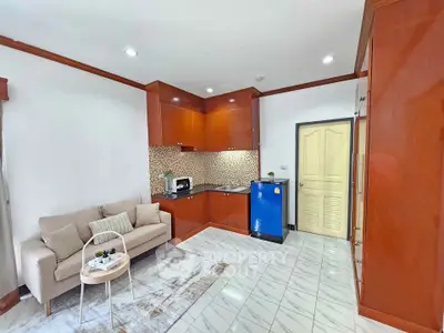 Charming studio apartment with cozy living area and compact kitchen featuring modern appliances.