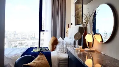 Luxurious bedroom with stunning city view, elegant decor, and modern lighting in high-rise apartment.