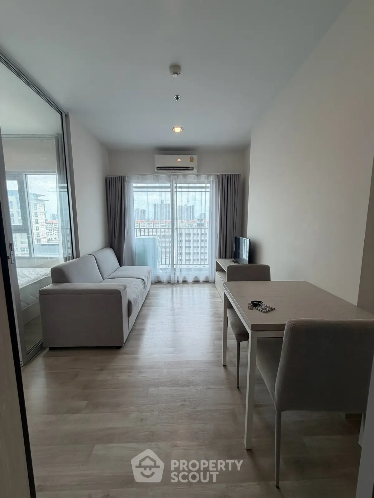 Modern living room with sleek furniture and city view, perfect for urban living.