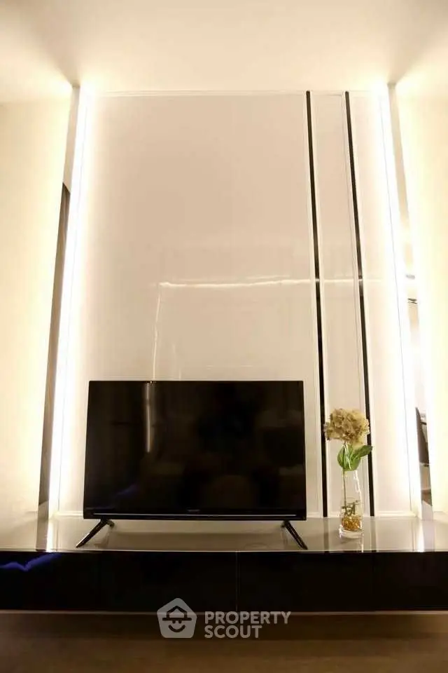 Modern living room with sleek TV setup and elegant lighting