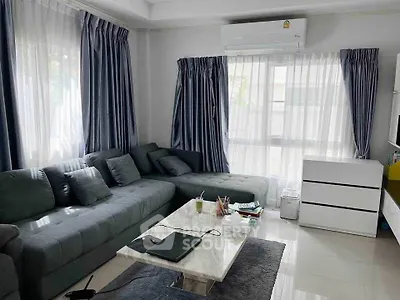 Spacious living room with modern gray sectional sofa and marble coffee table