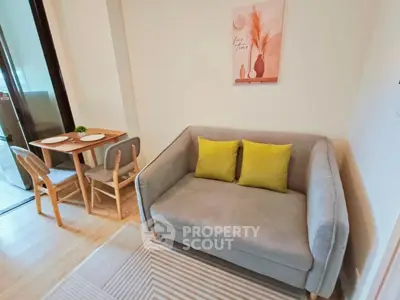 Cozy living room with modern sofa and dining area, perfect for small apartments.