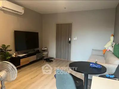 Cozy living room with modern decor, flat-screen TV, and comfortable seating, perfect for relaxation.
