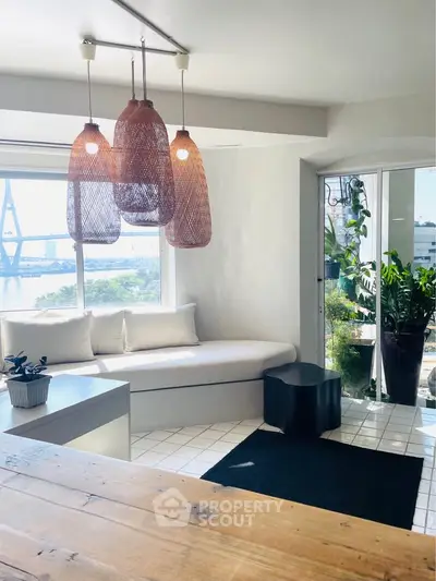 Bright living room with modern decor and large windows offering stunning bridge view.