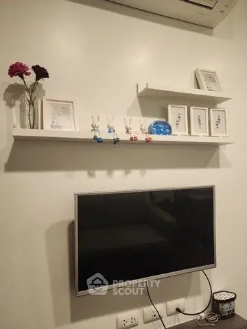 Modern living room with wall-mounted TV and decorative shelves