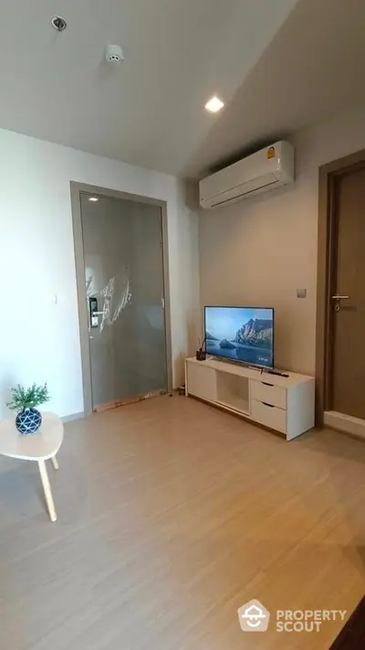 Modern living room with air conditioning and sleek TV setup