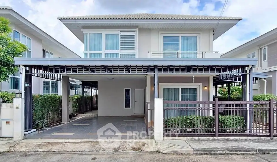 Modern two-story house with spacious driveway and contemporary design in a suburban neighborhood.