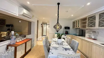 Charming dining area with elegant table setting and modern kitchen appliances.