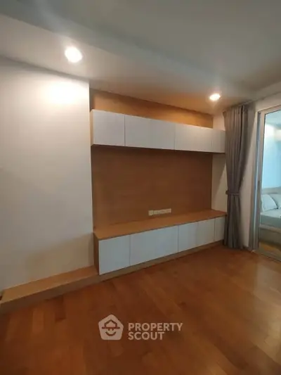 Modern living room with built-in wooden cabinets and sleek design