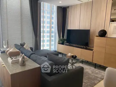 Modern living room with sleek furniture and large windows in urban apartment