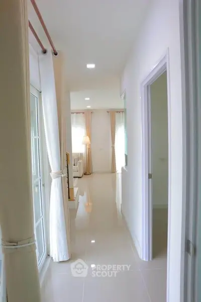 Bright hallway leading to a modern living room with elegant decor