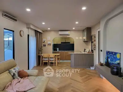 Modern open-layout living room with stylish kitchen and cozy seating area