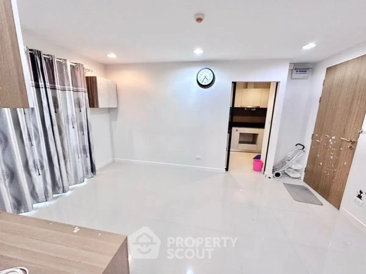 Spacious living room with modern decor and open kitchen layout