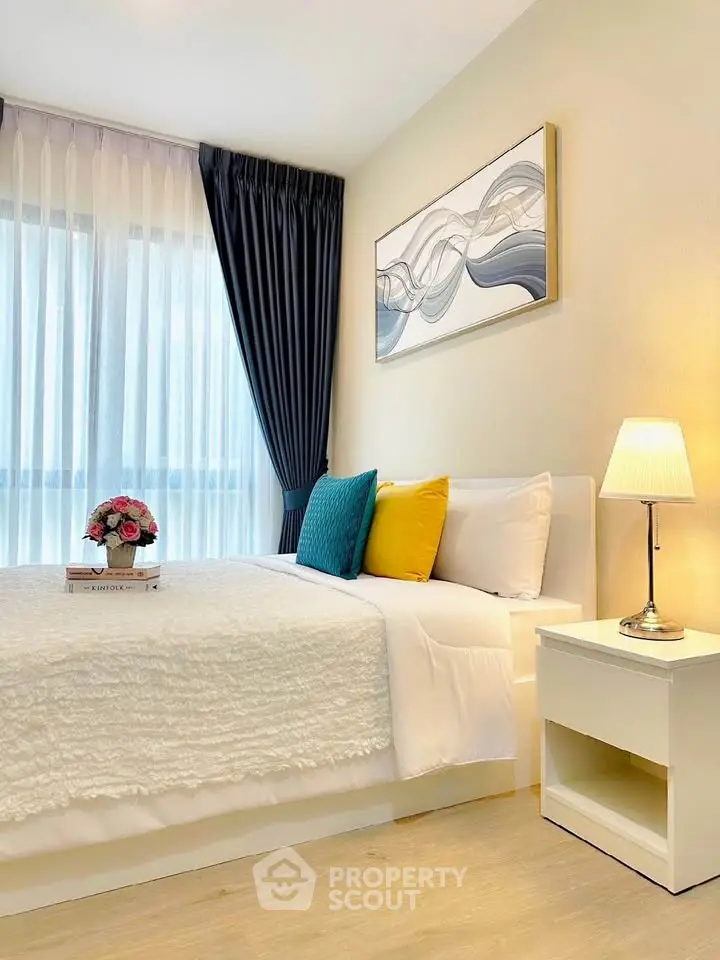 Modern bedroom with stylish decor, cozy bed, and elegant lighting in a bright apartment.