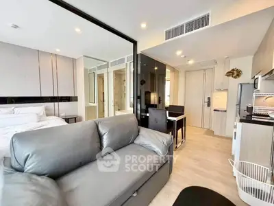Modern studio apartment with sleek design and open layout, featuring a cozy living area and stylish kitchen.