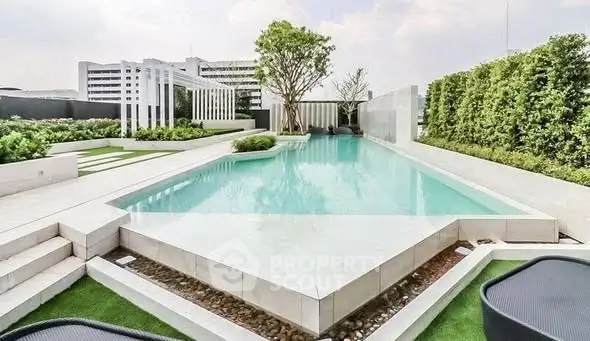 Luxurious rooftop pool with modern design and lush greenery