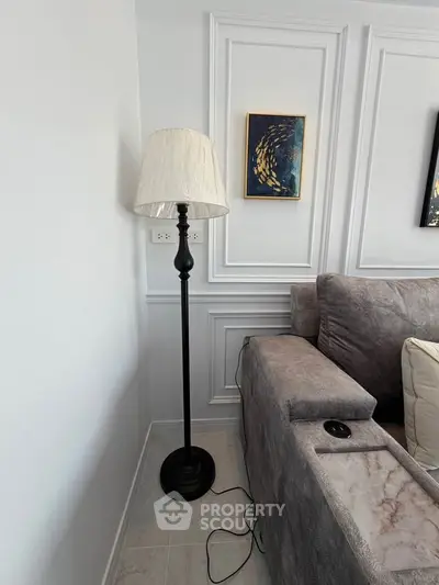 Elegant living room corner with stylish floor lamp and plush sofa, perfect for cozy relaxation.