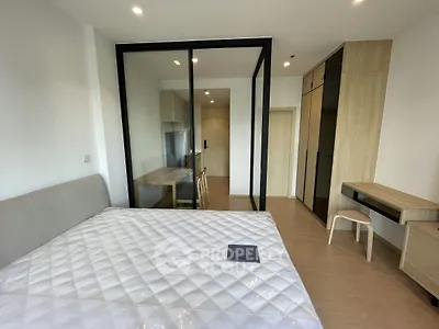 Modern bedroom with glass partition and stylish furniture in a contemporary apartment.