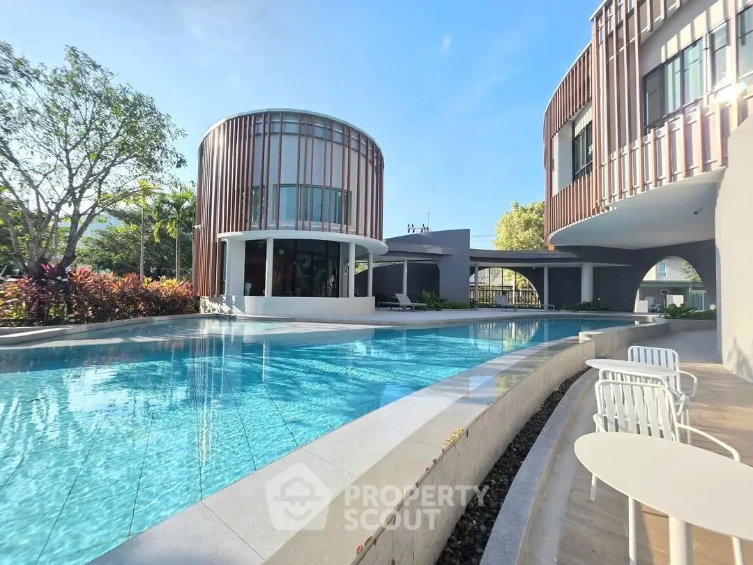 Luxurious modern poolside view with unique architectural design and lush greenery