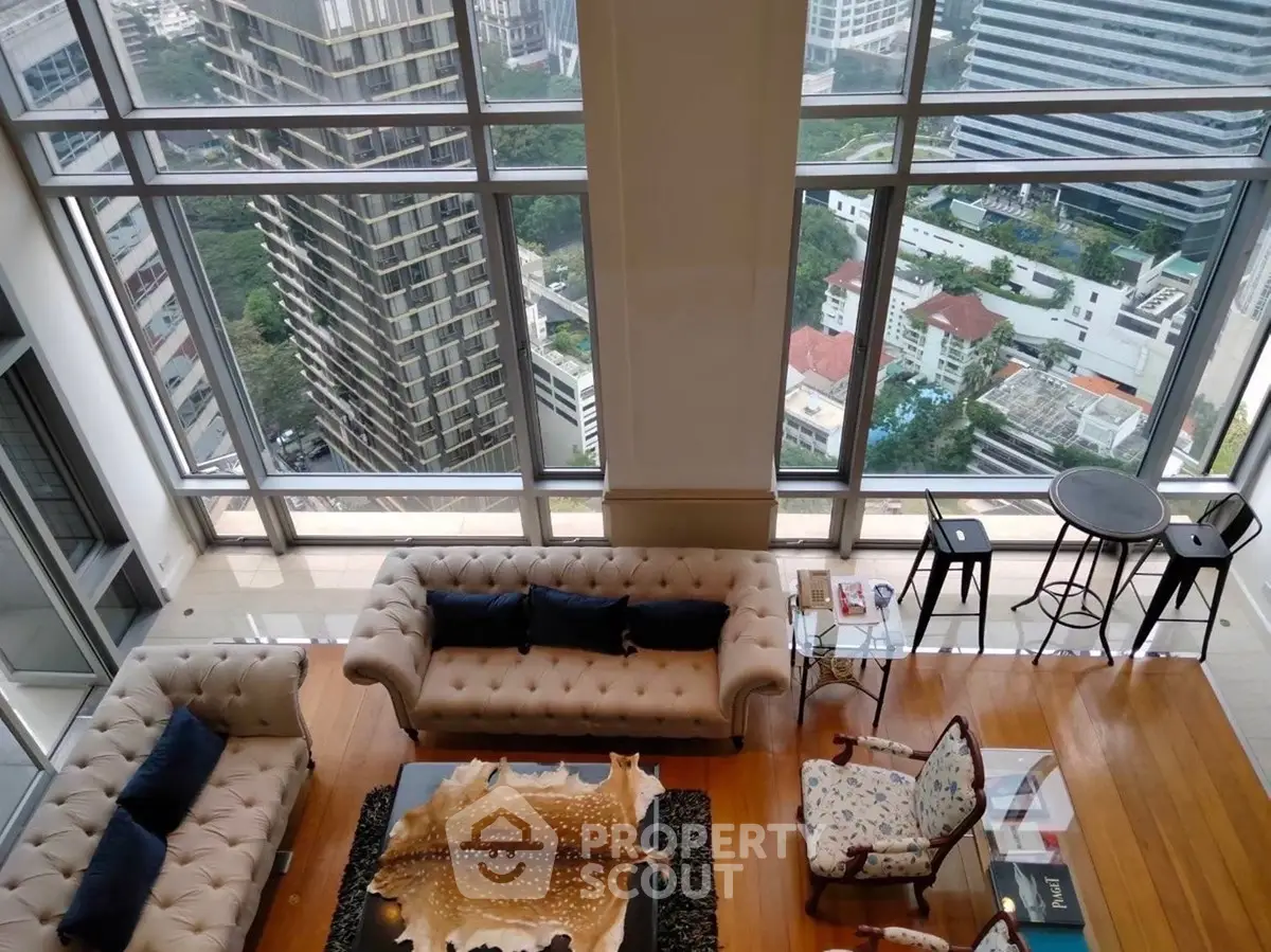 Luxurious high-rise living room with panoramic city views and elegant furnishings.