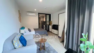 Modern studio apartment with cozy living area and stylish decor, featuring a compact kitchen and comfortable sleeping space.