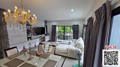 Luxurious living room with elegant chandelier and spacious seating area, perfect for modern living.