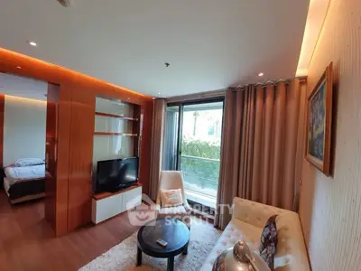 Modern living room with cozy seating and large window view
