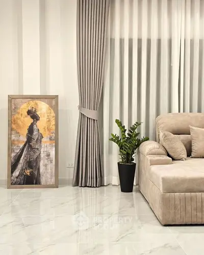 Elegant living room with plush sofa, stylish curtains, and modern artwork.