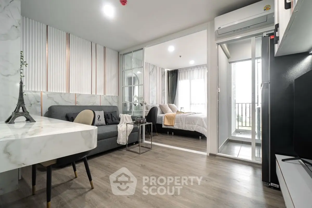 Modern open-plan living room with elegant decor and balcony view