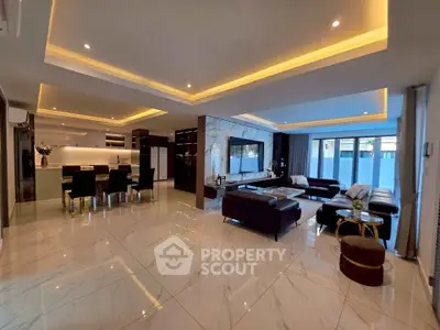 Luxurious open-plan living room with modern kitchen and elegant lighting