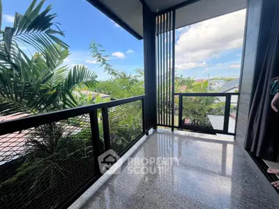 Spacious balcony with lush greenery and stunning sky view, perfect for relaxation and outdoor enjoyment.