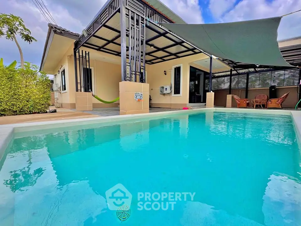 Charming villa with private pool and outdoor seating area, perfect for relaxation.