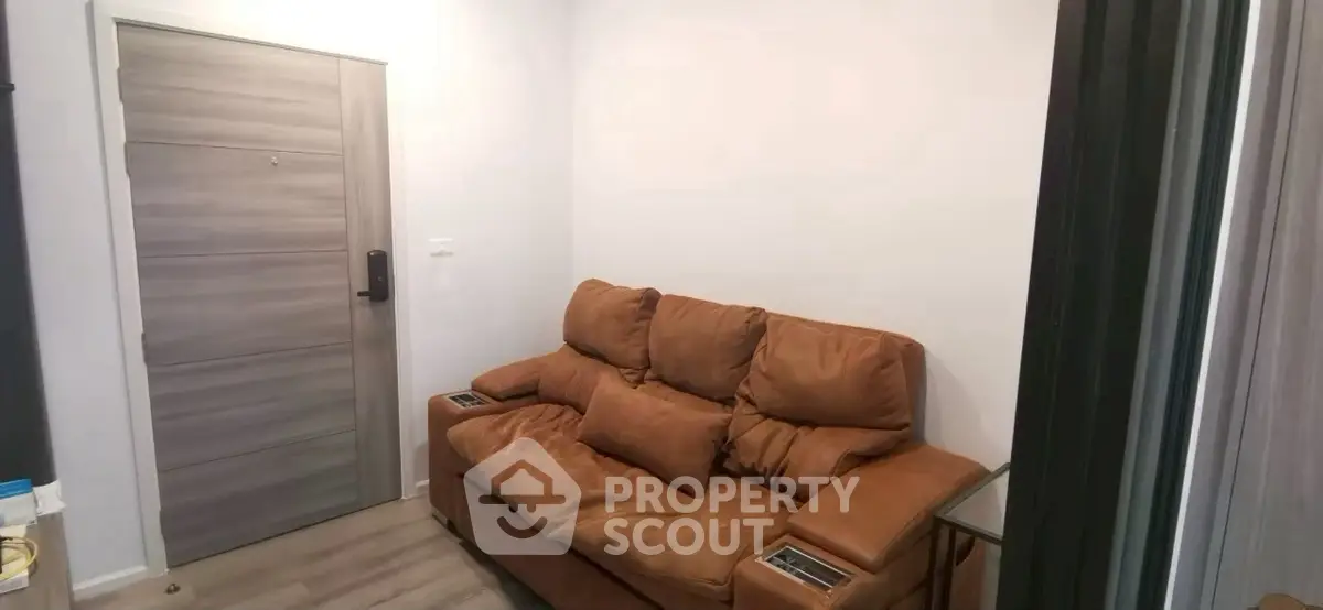 Cozy living room with plush brown sofa and modern wooden door