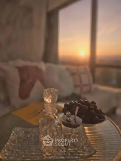 Luxurious living room with sunset view, elegant decor, and cozy ambiance.