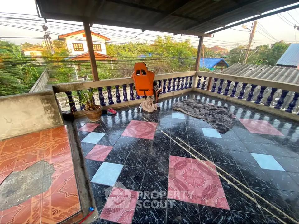 Spacious rooftop terrace with colorful tiled flooring and scenic neighborhood view.