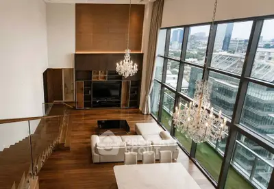 Luxurious high-rise living room with floor-to-ceiling windows and stunning city views.