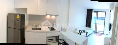 Modern kitchen and living area with sleek design and natural light