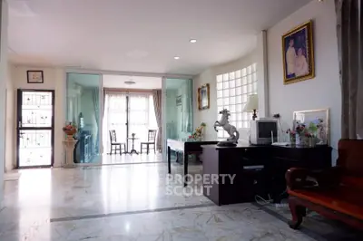 Spacious living room with elegant marble flooring and natural light