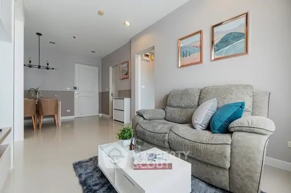 Modern living room with cozy sofa and stylish decor in a contemporary apartment.