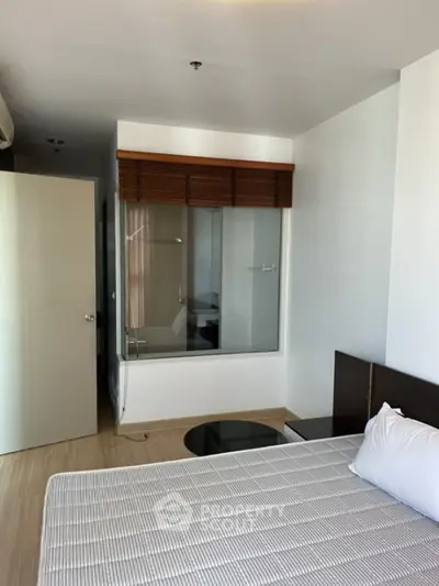 Modern bedroom with glass partition and minimalist decor